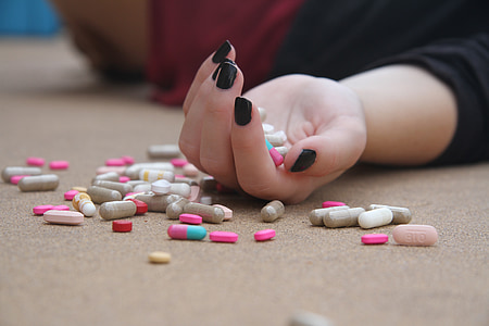 person hand holding medication pills thumbnail