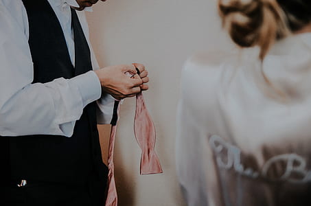 person holing pink necktie thumbnail