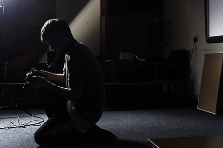 man sitting in dark room thumbnail