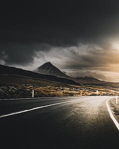 road going through trees and mountains thumbnail