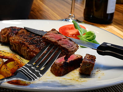 fork with sliced beef on table thumbnail