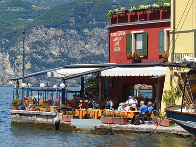 red and white restaurant near body of water thumbnail