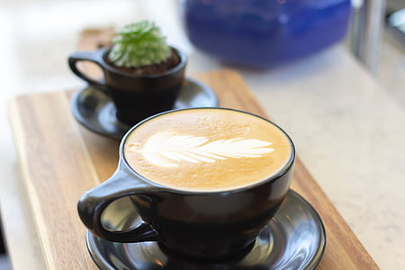 selective focus photography of cup filled with cappuccino thumbnail