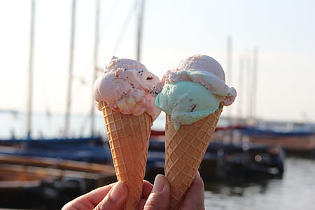 person holds two flavored ice creams thumbnail