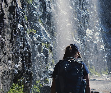Person Walking Under Waterfalls thumbnail