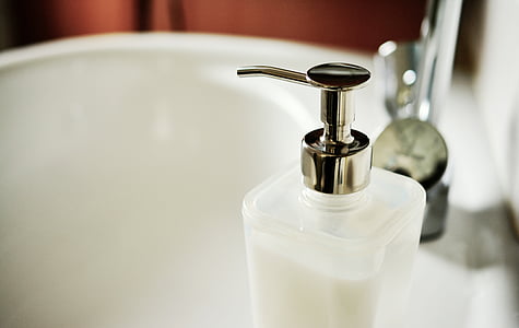 clear glass pump bottle on ceramic sink thumbnail