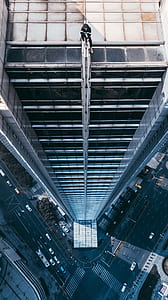 person sitting on top of high rise building during daytime thumbnail