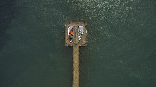 aerial photography of grey wooden dock on top of body of water at daytime thumbnail