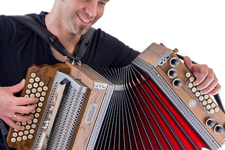 man smiling while playing accordion thumbnail