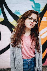 girl wearing cardigan with graffiti behind her thumbnail