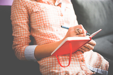 Girl Writing in her Moleskine Diary thumbnail