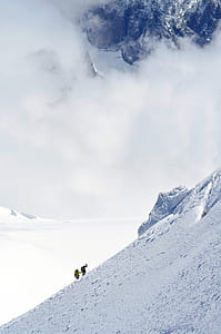 two person climbing on snow field mountain thumbnail