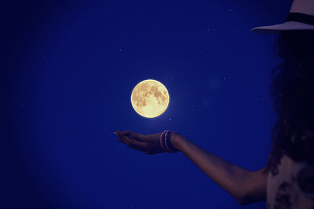 woman in white dress and white hat with a background of full moon thumbnail