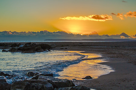 photo of seashore under golden sky thumbnail