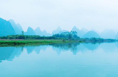 body of water near grass field thumbnail