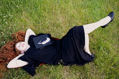 woman lying on green grass field thumbnail