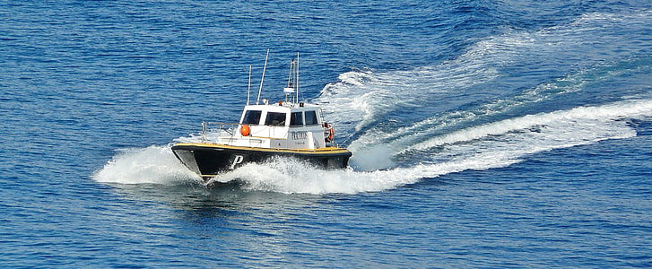 white and black police boat in the middle of body water thumbnail