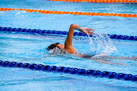 person swimming on pool during daytime thumbnail