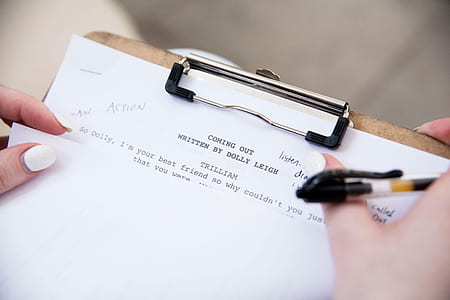 person holding paper in clip board thumbnail