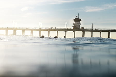 white lighthouse on bridge at daytime thumbnail