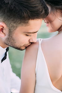 man kissing woman on left shoulder thumbnail