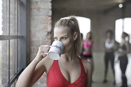 woman holding white ceramic mug thumbnail