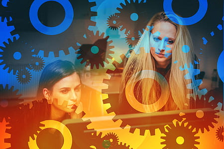 two women near each other with black and blue gear background thumbnail