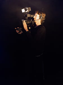 Man Wearing Black Long-sleeved Shirt Using Video Camera thumbnail