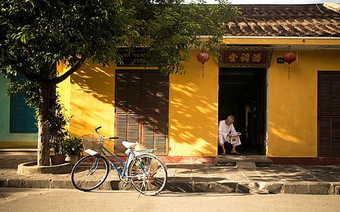 parked black bike near building thumbnail