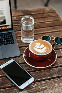 rose gold iPhone 7 Plus beside teacup with latte thumbnail