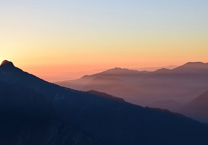 silhouette of mountain under cloudy sky thumbnail