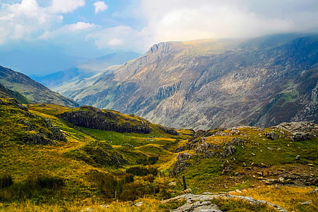 mountains covered with green grasses unde rblue sky thumbnail