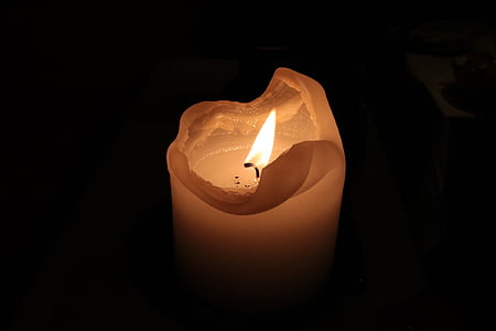 ignited white pillar candle thumbnail