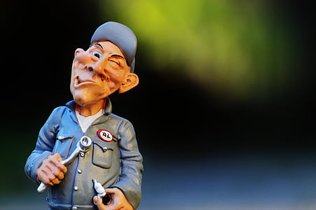 selective focus photography of male carpenter figurine thumbnail