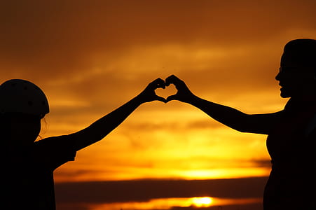 Silhouette of Man Touching Woman Against Sunset Sky thumbnail