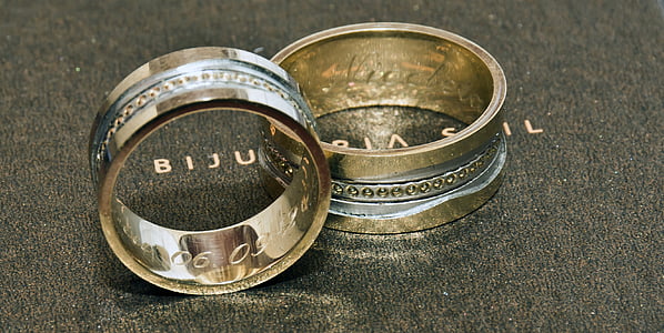 two gold-colored rings on gray surface thumbnail