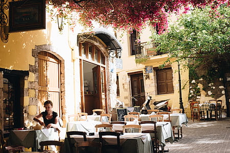 Woman Wearing Black Scoop-neck Cap-sleeved Blouse Eating on Cafeteria With White Table Arrangements thumbnail