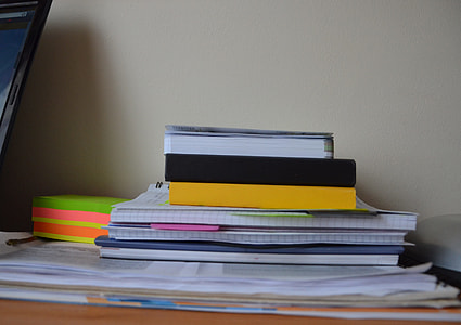 pile of books on the desk with pink paper thumbnail