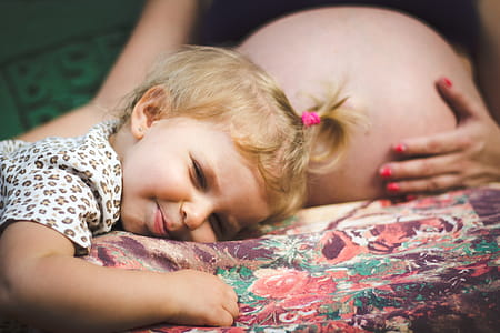 Baby Lying on Pregnant Woman's Lap thumbnail