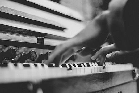 grayscale photography of person playing piano thumbnail