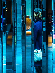 woman standing near mirror wall thumbnail
