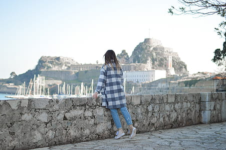 woman standing beside concrete rail thumbnail