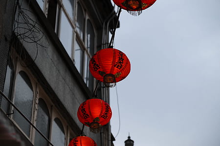 worm's eye view photography of red hanging lanterns thumbnail
