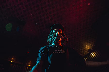 low-light photo of man wearing black t-shirt thumbnail