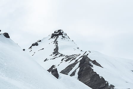glacier mountain under white clouds photo during daytime thumbnail