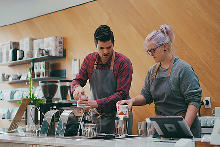 woman in space dye crew-neck sweater mixing cream beside man in red and blue plaid dress shir thumbnail