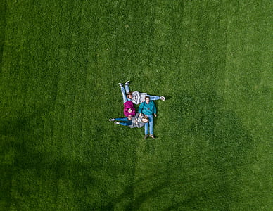 bird's eye view of group of people lying down on grass thumbnail