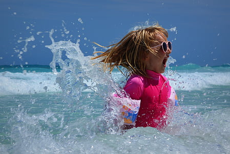girl in pink rash guard in beach thumbnail