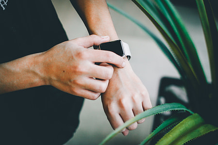 selective focus photography of person wearing Apple Watch thumbnail