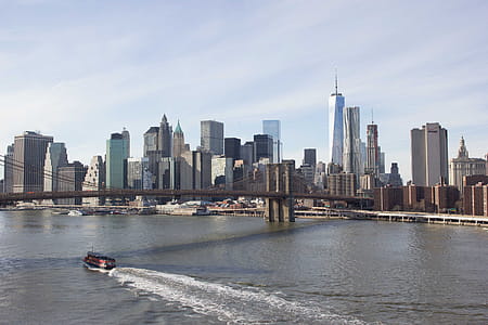 A boat passes under Brooklyn bridge in New York thumbnail